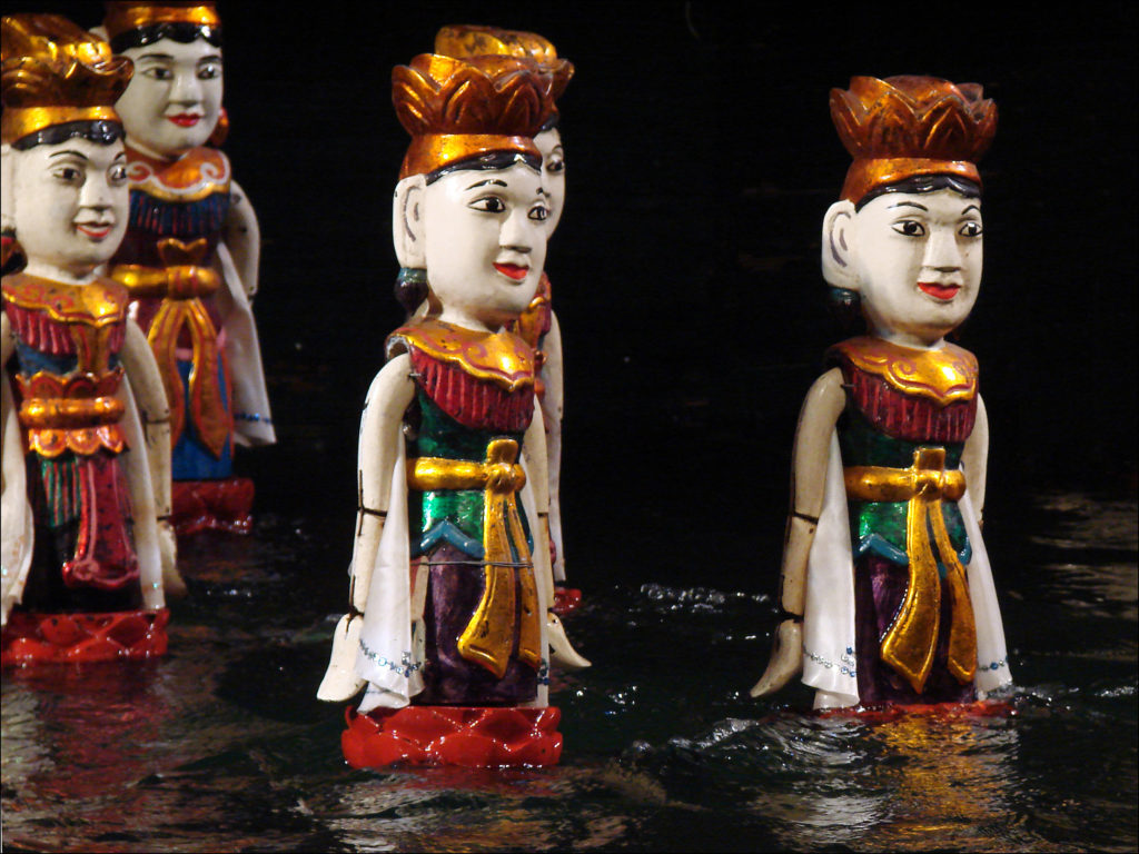 A photo of Vietnamese water puppets in the water at the Thang Long Theatre in Hanoi.