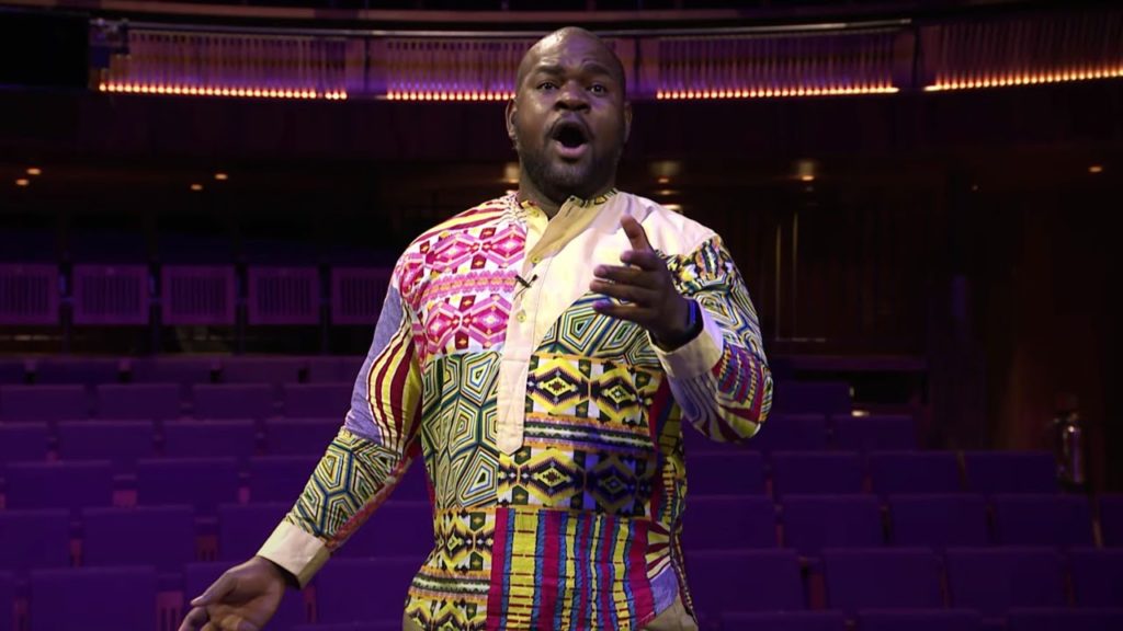 A photo of opera singer Blaise Malaba mid-performance.