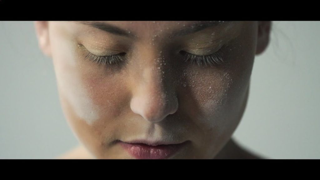 A close up photo of the face of dancer Imogen McManus from the video Star by VOCES8.