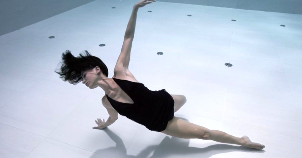 A photo still of dancer Julie Gautier mid-performance underwater.
