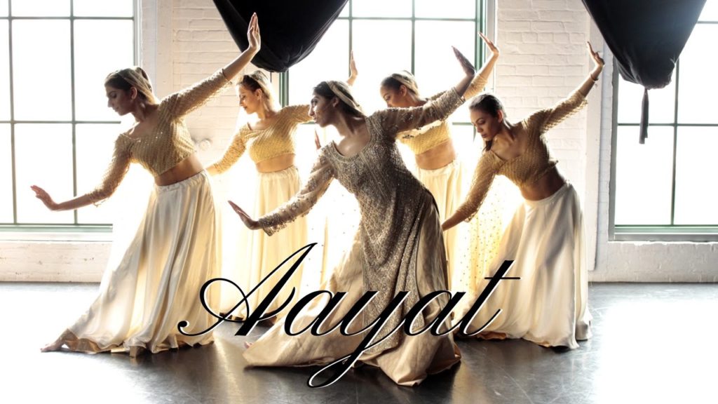 A photo still of Shereen Ladha and four additional dancers, mid-pose, from the video of Aayat dance.