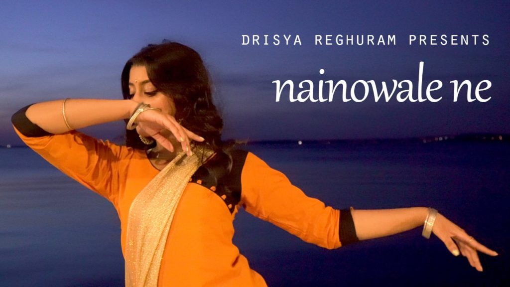 A close up photo still of dancer Drisya Reghuram mid-performance of the piece Nainowale Ne.
