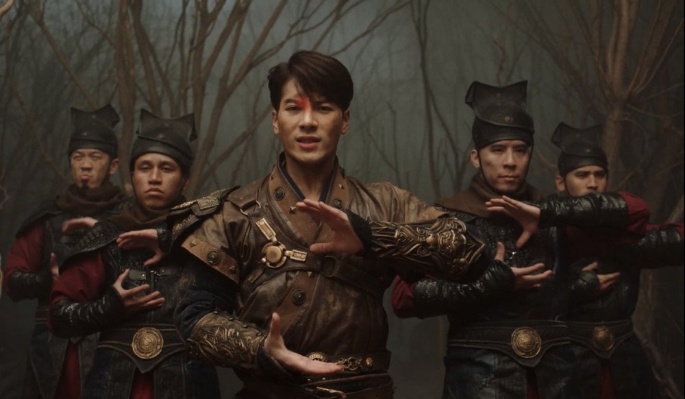 A photo still from the music video 100 Ways by Jackson Wang, showing Wang and four backup dancers looking straight at the camera.