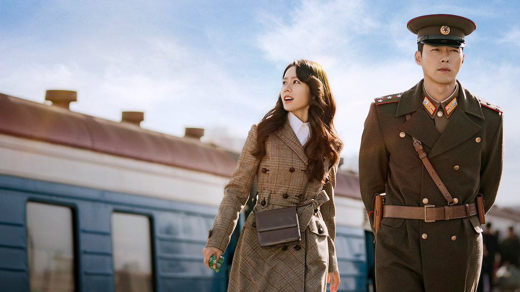 A promotional photo for the TV show Crash Landing on You featuring lead actors Son Ye-jin and Hyun Bin.