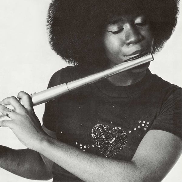 A close up black and white photo of Bobbi Humphrey playing the flute.