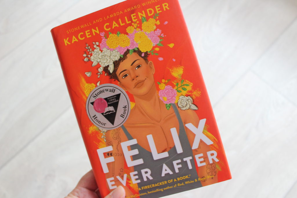 A close of photo of the cover of Felix After Ever by Kacen Callender. The image is a drawing of the titular Felix, wearing a grey tank top and a crown of flowers.