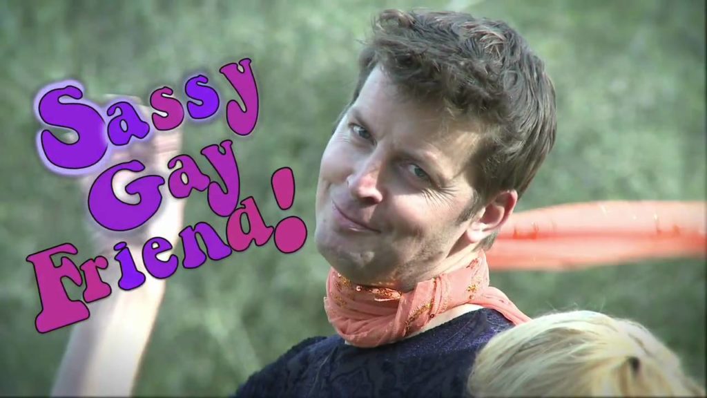 A photo from the web series Sassy Gay Friend. The photo is of comedian Brian Gallivan looking directly into the camera, smirking as he tosses his scarf over his shoulder.