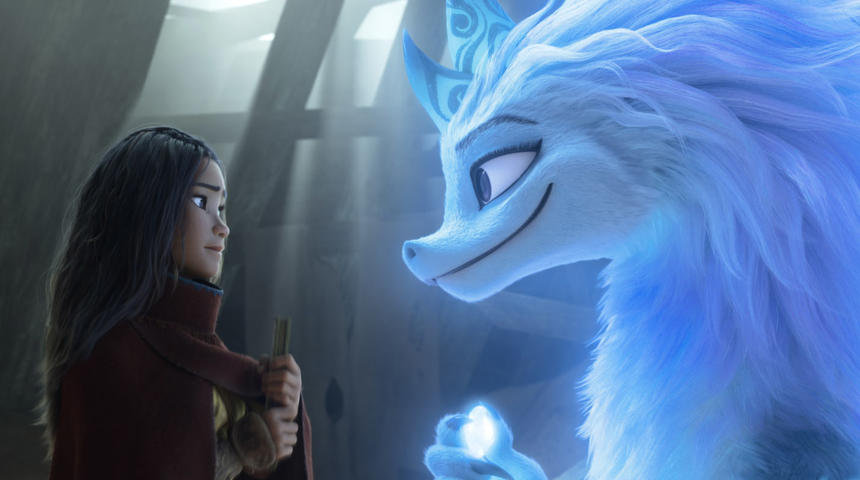 A photo still from Raya and the Last Dragon. Raya and the dragon Sisu are looking at each other fondly in profile.