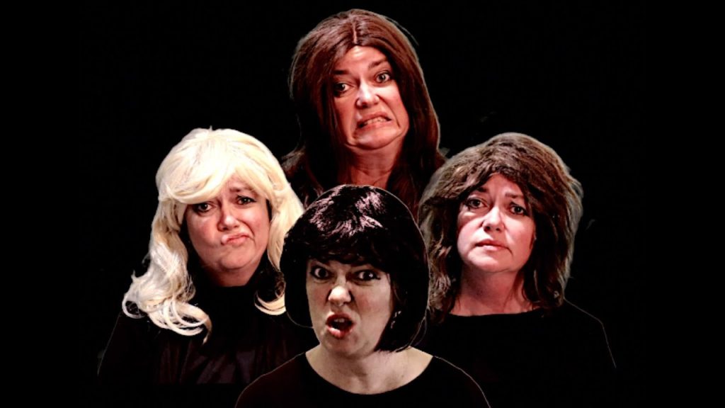 A photo still from Menopause Rhapsody. Four women, all played by the same woman, are looking straight into the camera with a black background in a parody of the Bohemian Rhapsody video.