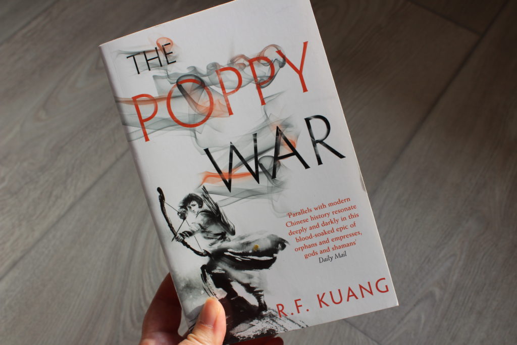 A close up photo of the cover of The Poppy War by RF Kuang.