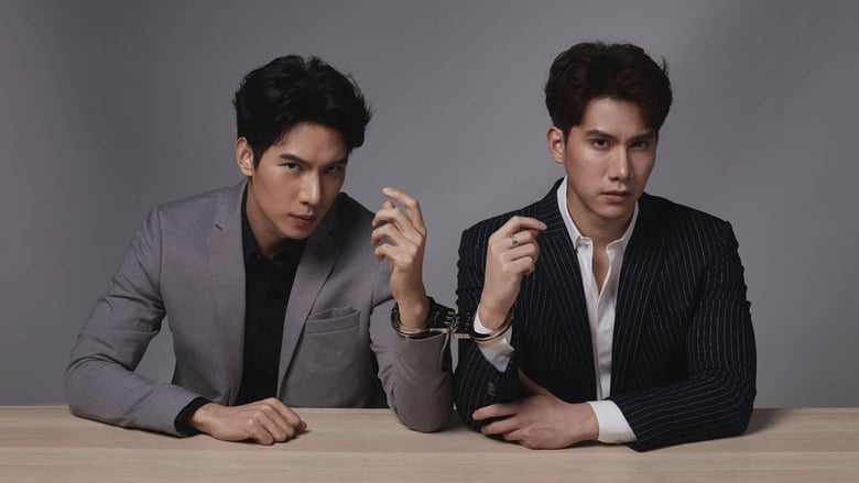 A promotional still from the TV show Manner of Death. Lead actors Max Nattapol Diloknawarit and Tul Pakorn Thanasrivanitchai are sitting behind a table wearing suits, their hands connected by handcuffs.