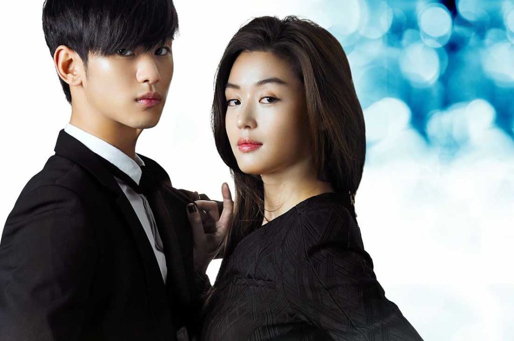 A promotional photo from My Love from the Star. Lead actors Kim Soo-hyun and Jun Ji-hyun facing each other but looking over their shoulders directly into the camera.