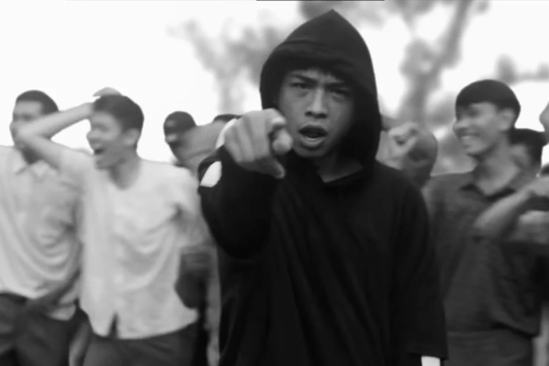 A black and white photo from a music video by Rap Against Dictatorship