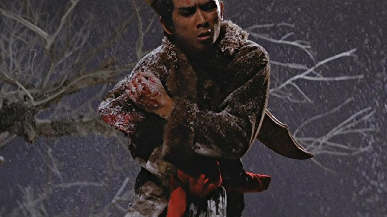 A photo still from the wuxia film The One Armed Swordsman. It shows lead actor, Jimmy Wang, holding the bloodied spot where he's now missing an arm.
