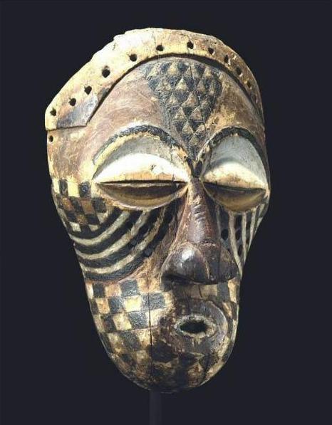 A photo of a Kuba mask against a black background.