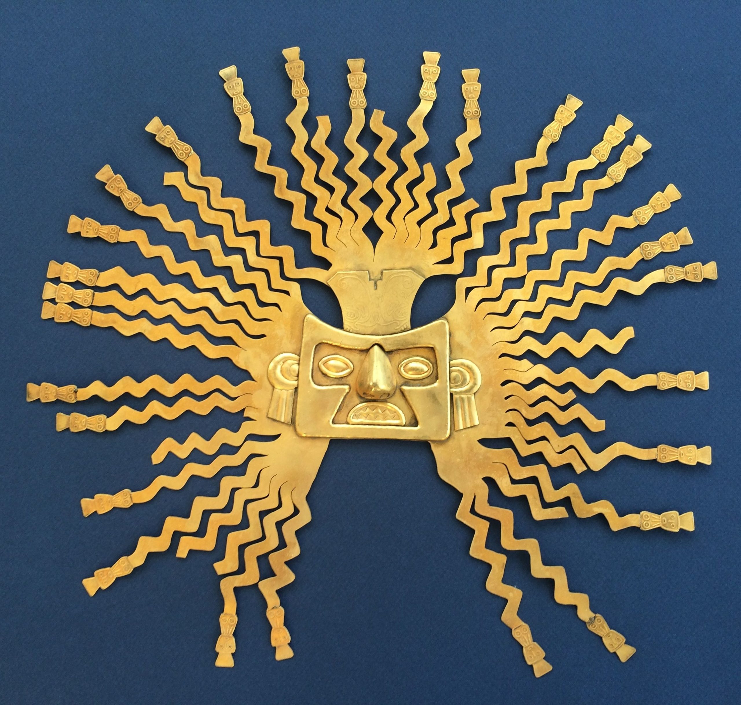 A photo of a golden mask of Inti, the Sun God in Andean mythology