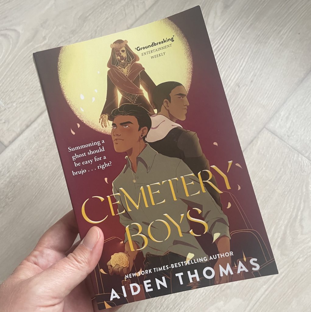 A close up photo of the cover of Cemetery Boys by Aiden Thomas.