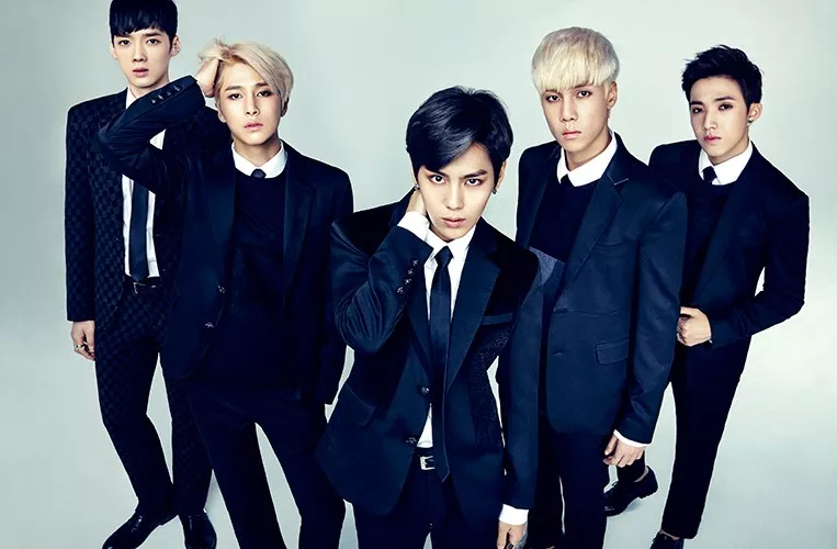 A promotional photo of Boys Republic. The five members are standing in a V staring straight at the camera.