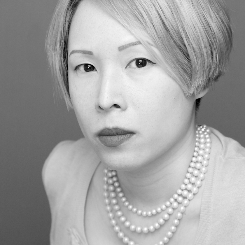 A black and white close up photo of Jane Yeh looking straight into the camera.