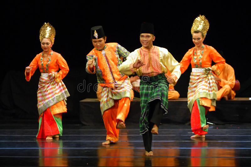 A photo of Zapin Tenglu dancers mid-performance and in costume onstage.