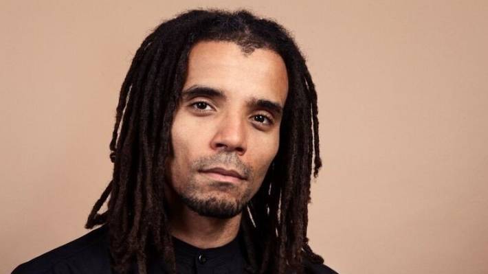 A headshot of Akala. It is taken from the shoulders up, and he is looking straight at the camera.