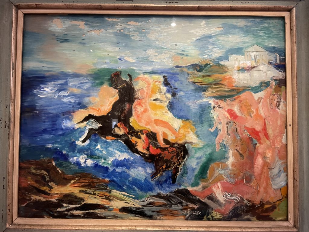 A photo of a painting by Valentine Prax. It is multicoloured and shows a figure on a horse in the middle of a body of water, but overall it is very abstract.