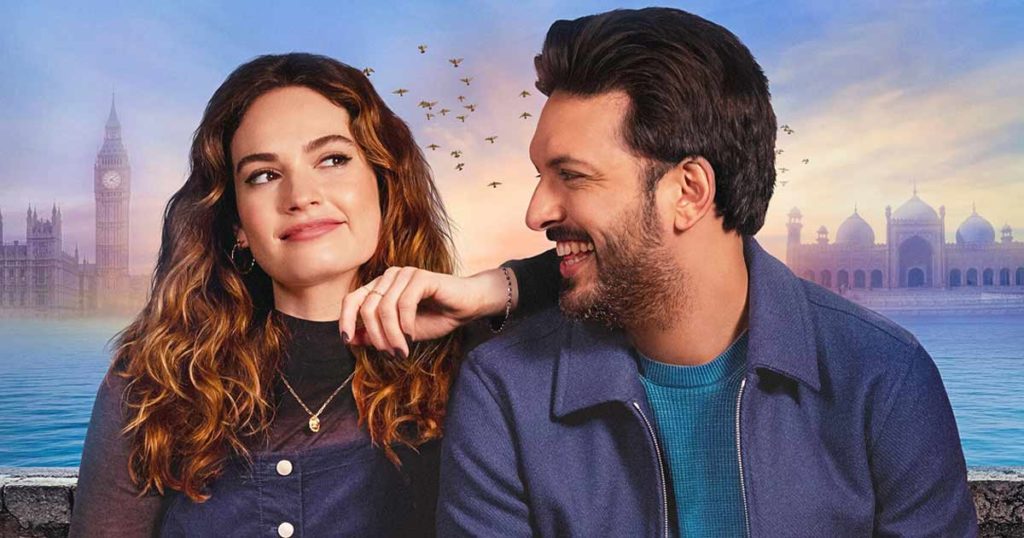 A promotional photo from What's Love Got To Do With It? I depicts lead actors Shazad Latif and Lily James, sitting side by side on a bench, smiling at each other.