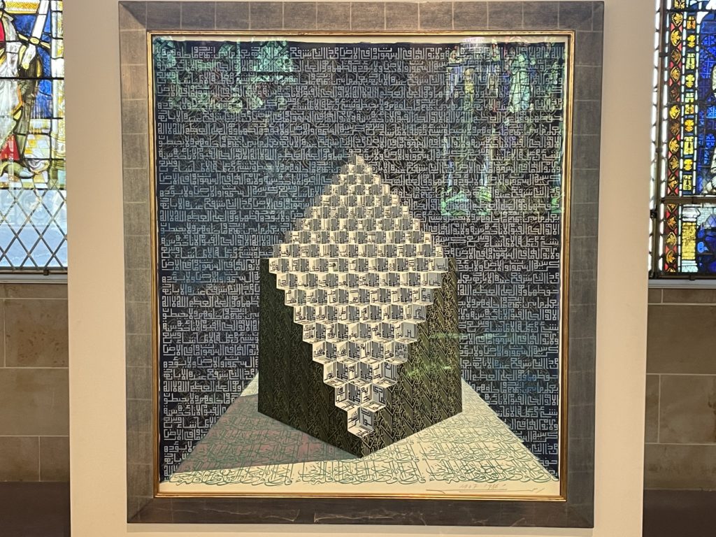 An image of an artwork by Ahmed Moustafa. It shows a cube with a slanted side in the shape of a diamond, and the outline of both the cube and then background is all done in calligraphy.