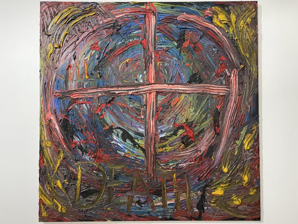 A photo of the painting Death by Derek Jarman. It is an abstract painting with a cross inside a circle, and the word Death inscribed in the paint along the bottom.