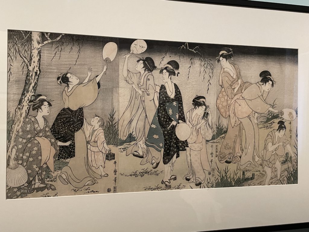 An image of a painting by Kitagawa Utamaro. It depicts several women and children catching fireflies outdoors.