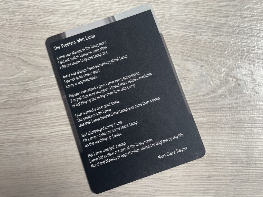 A photo of a card with the poem "The Problem with Lamp" written out on it, by Mairi-Claire Traynor.