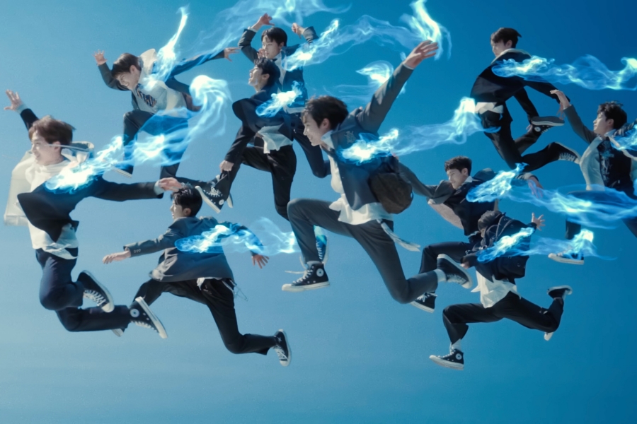 A photo still from the video for Rockstar by xikers. The ten members are in profile, jumping through the air.