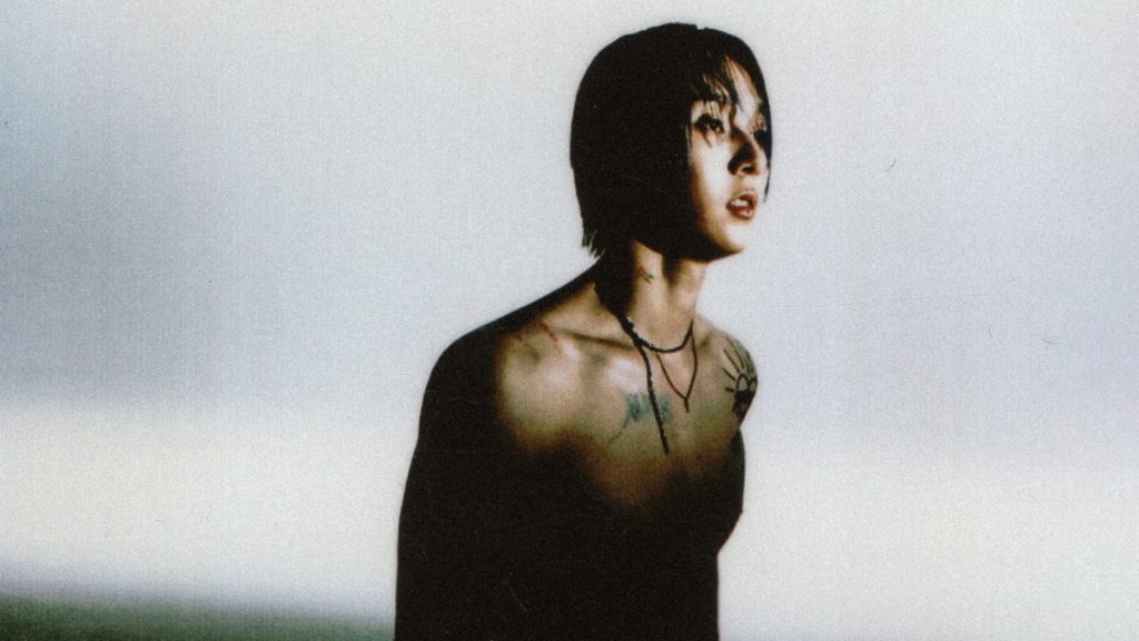 A photo of Dawn. He is seen from the waist up, bare chested, looking off camera right.