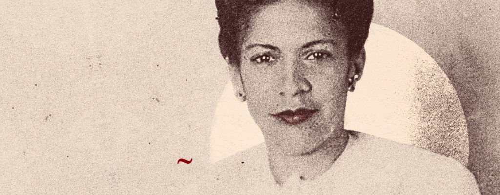 A close up photo of Aida Cartagena Portalatin. It is an old photo, so the quality is grainy, but it is a profile of the poet looking straight into the camera.