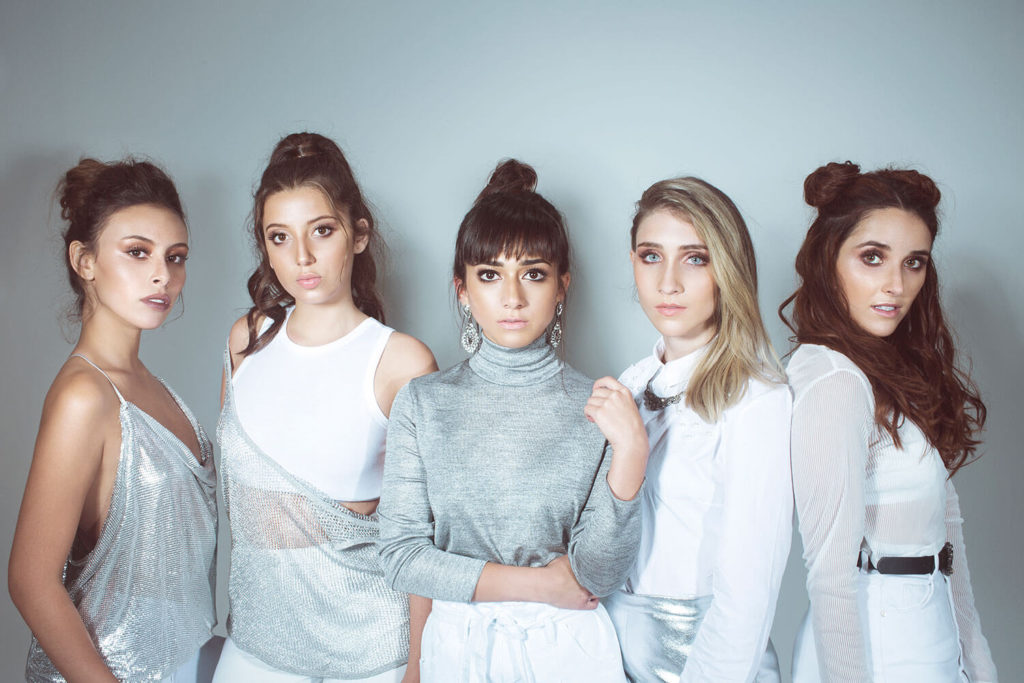 A promotional photo of Ventino. The five members are wearing white and light blue tops, they are standing in a line, and posing directly towards the camera.