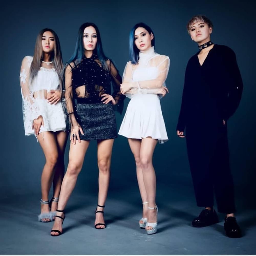 A promotional photo of IceBlue. The four members are standing in full profile in a line, two in white, two in black, staring straight into the camera.